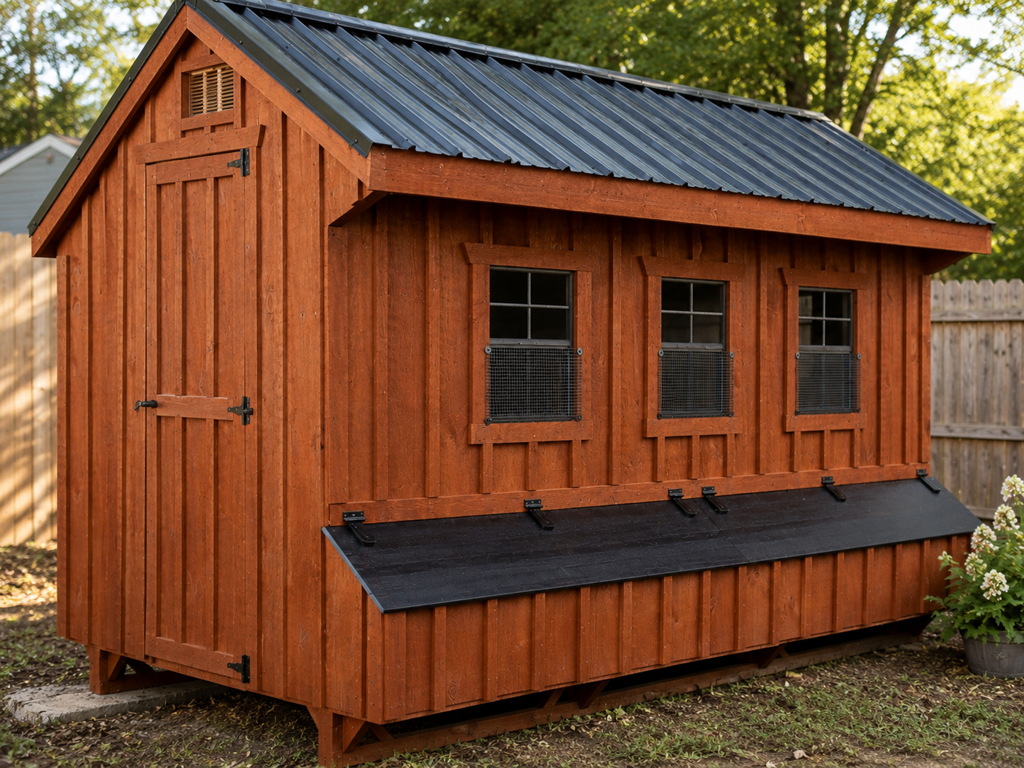 Close-up of 7x12 cedar-stained Quaker chicken coop showing black metal roof, windows, nesting box, and wood siding details