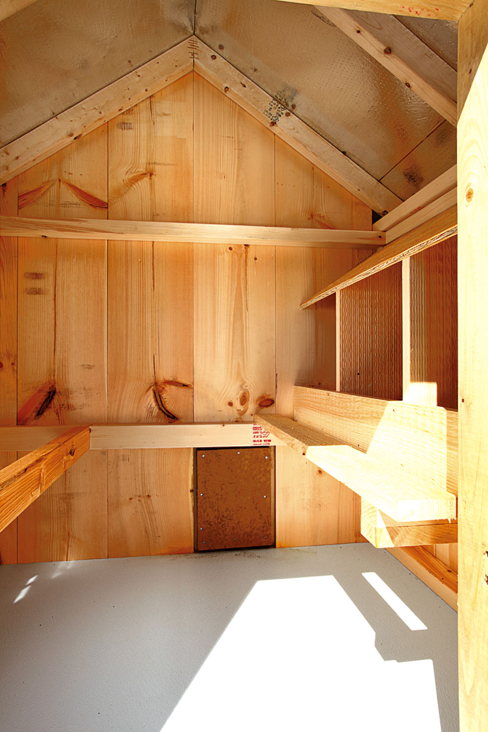 Interior of A57C chicken coop showing nesting box and roost area