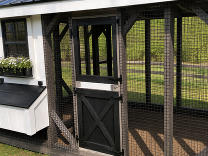 Close-up of black Dutch door and heavy-duty wire run on a premium 7x20 custom chicken coop.