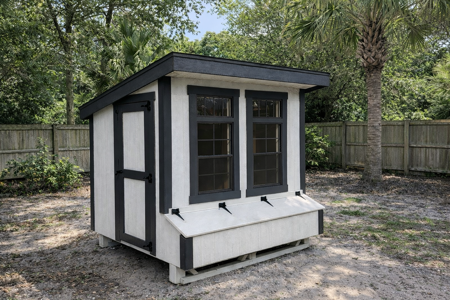 Amish built modern chicken coop in suburban backyard with nesting boxes and black trim