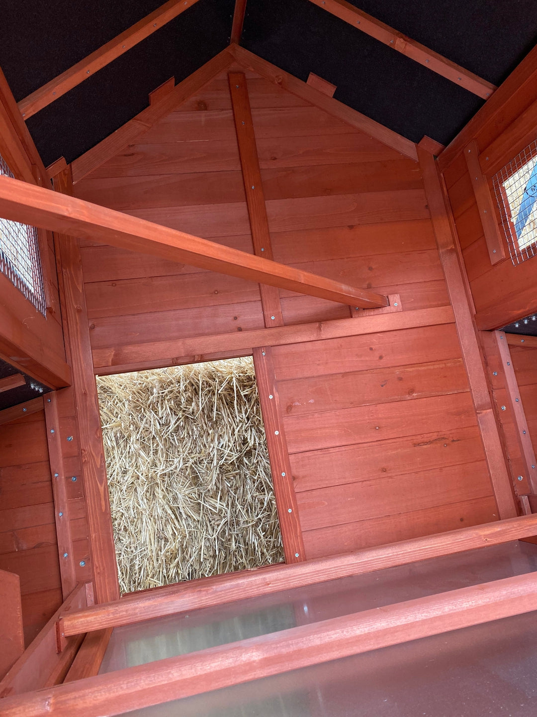 Close-up of Orpington Lodge chicken coop sliding pull-out waste tray showing easy cleaning system beneath the hen house floor