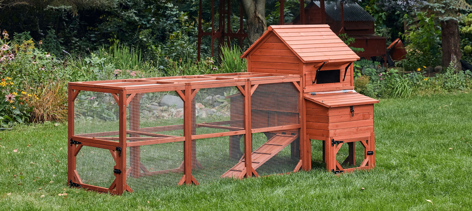 Orpington Lodge backyard chicken coop with attached run extension fully assembled on grass showing complete small flock kit setup