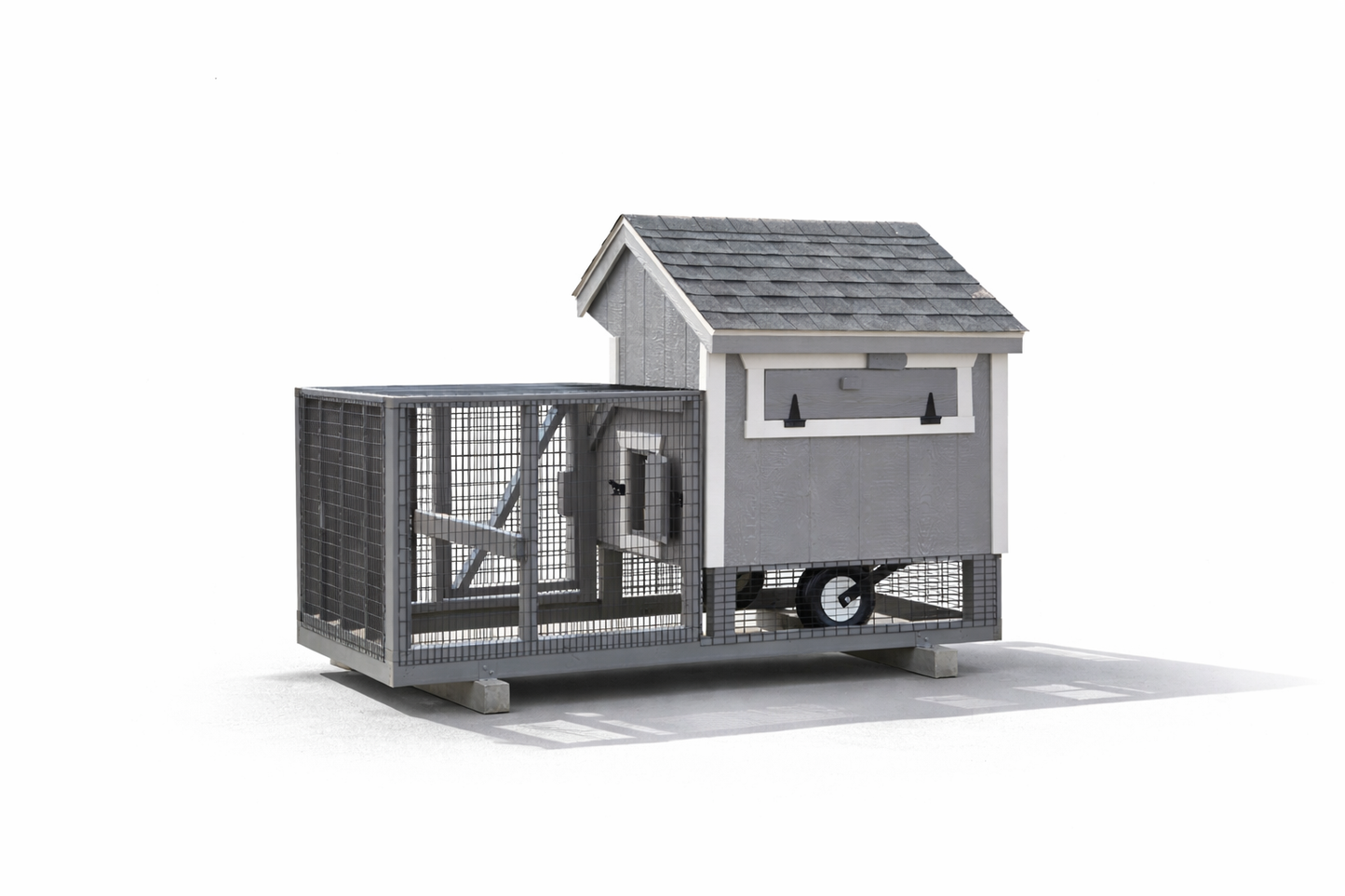 Rear view of a dark gray chicken coop with enclosed wire run on white background